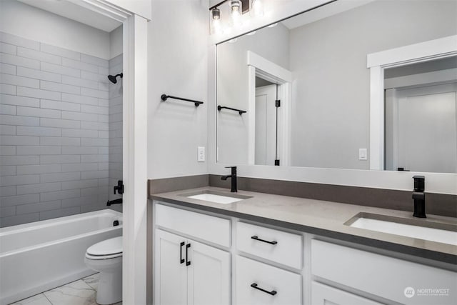 full bathroom featuring vanity, toilet, and tiled shower / bath combo