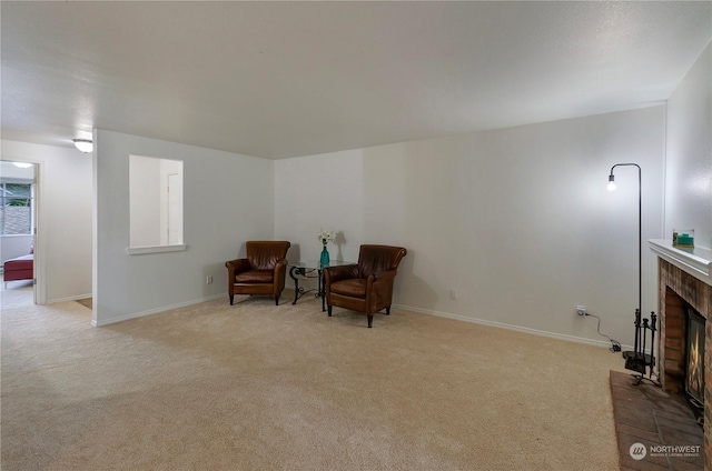 sitting room with light carpet and a fireplace