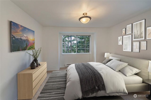 carpeted bedroom featuring baseboard heating