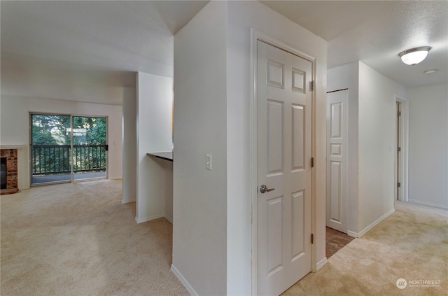 corridor featuring light colored carpet