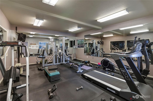 exercise room featuring a textured ceiling