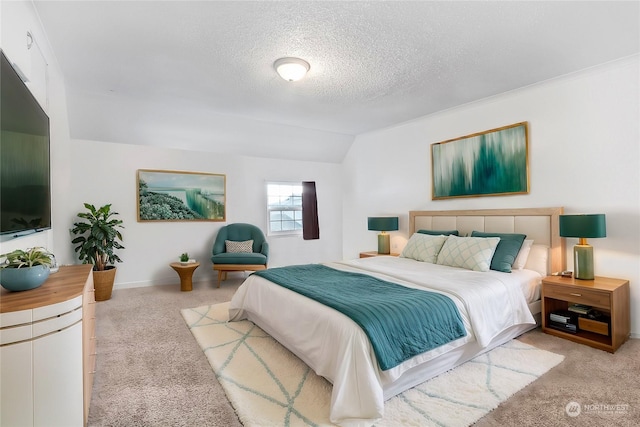 bedroom with light colored carpet, a textured ceiling, and vaulted ceiling