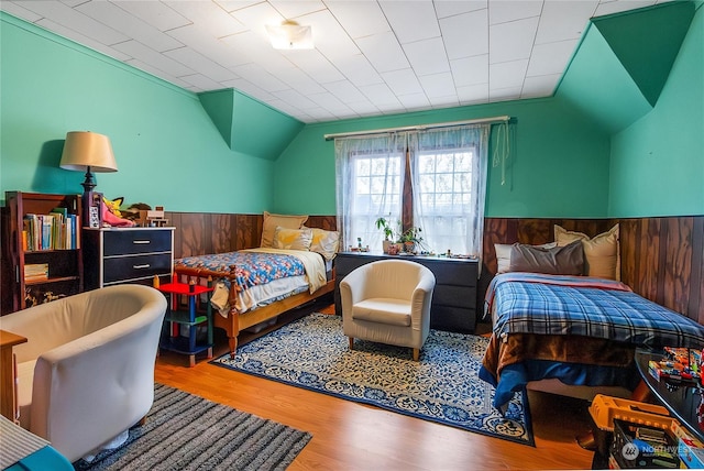 bedroom with hardwood / wood-style floors and vaulted ceiling