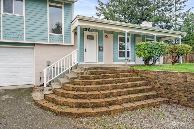 view of front of house featuring covered porch and a garage