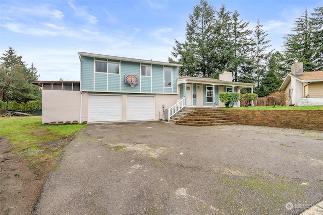 view of front of home featuring a porch and a garage