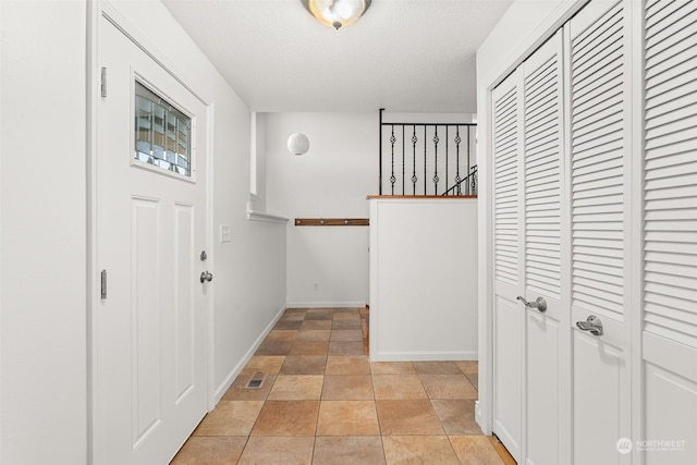 foyer entrance with a textured ceiling