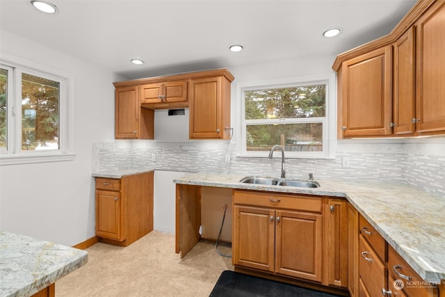 kitchen with backsplash, a healthy amount of sunlight, and sink