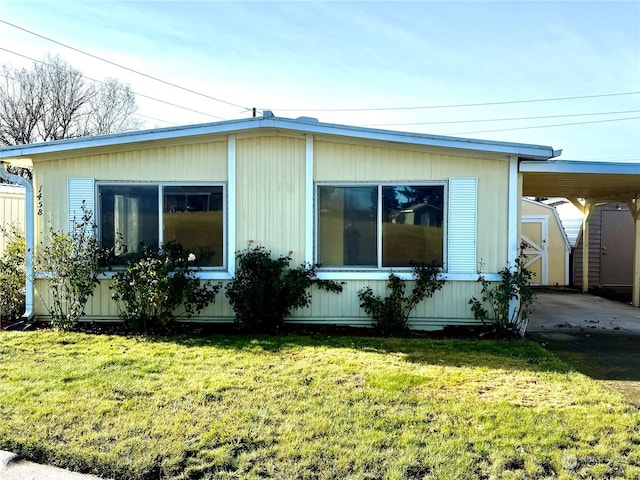 view of property exterior featuring a lawn and a storage shed