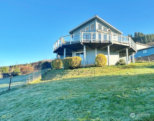 back of house with a yard and a deck