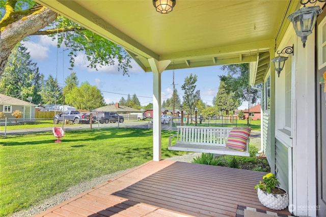 exterior space featuring a lawn and covered porch