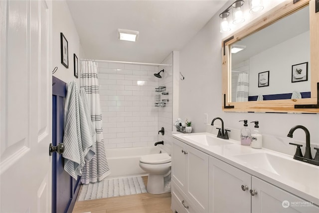 full bathroom featuring hardwood / wood-style floors, vanity, toilet, and shower / bath combo with shower curtain