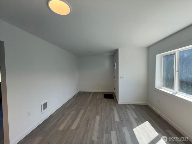 1306 Melbourne Ct, Westport, WA 98595 - unfurnished living room featuring visible vents, wood finished floors, and baseboards