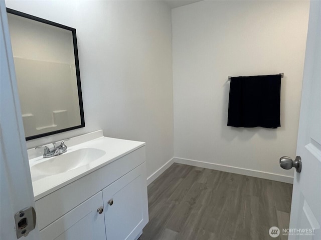 1306 Melbourne Ct, Westport, WA 98595 - bathroom featuring vanity, baseboards, and wood finished floors