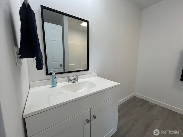 1306 Melbourne Ct, Westport, WA 98595 - bathroom with baseboards, vanity, and wood finished floors