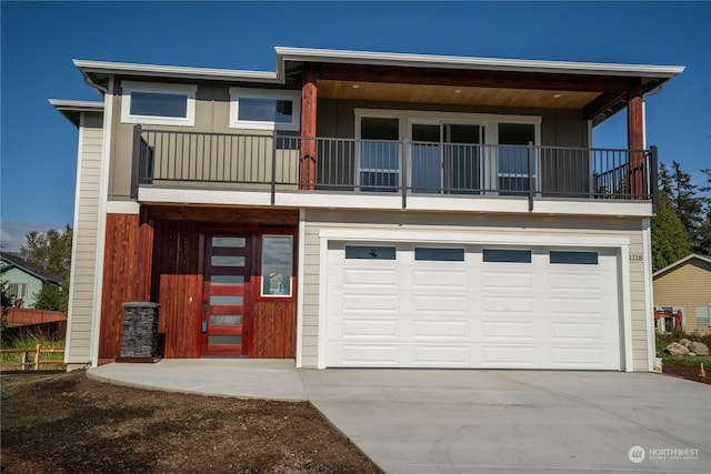 view of front facade with a garage and a balcony