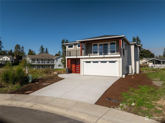 view of front facade with a garage, a balcony, and central air condition unit