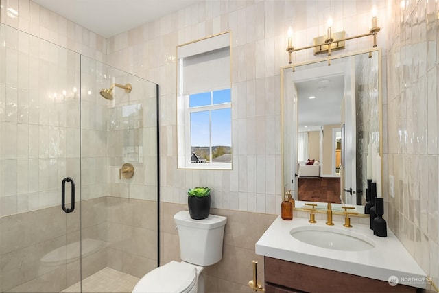 full bathroom with a shower stall, tile walls, and vanity