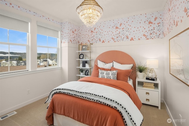 bedroom with a chandelier, carpet, visible vents, and baseboards