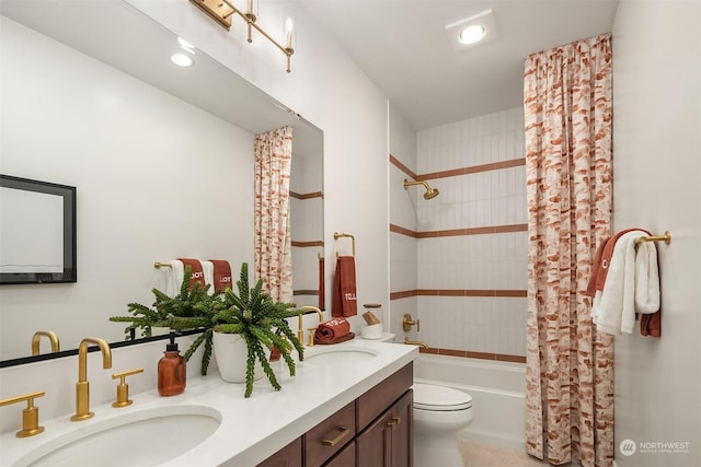 bathroom featuring shower / bath combination with curtain, a sink, toilet, and double vanity