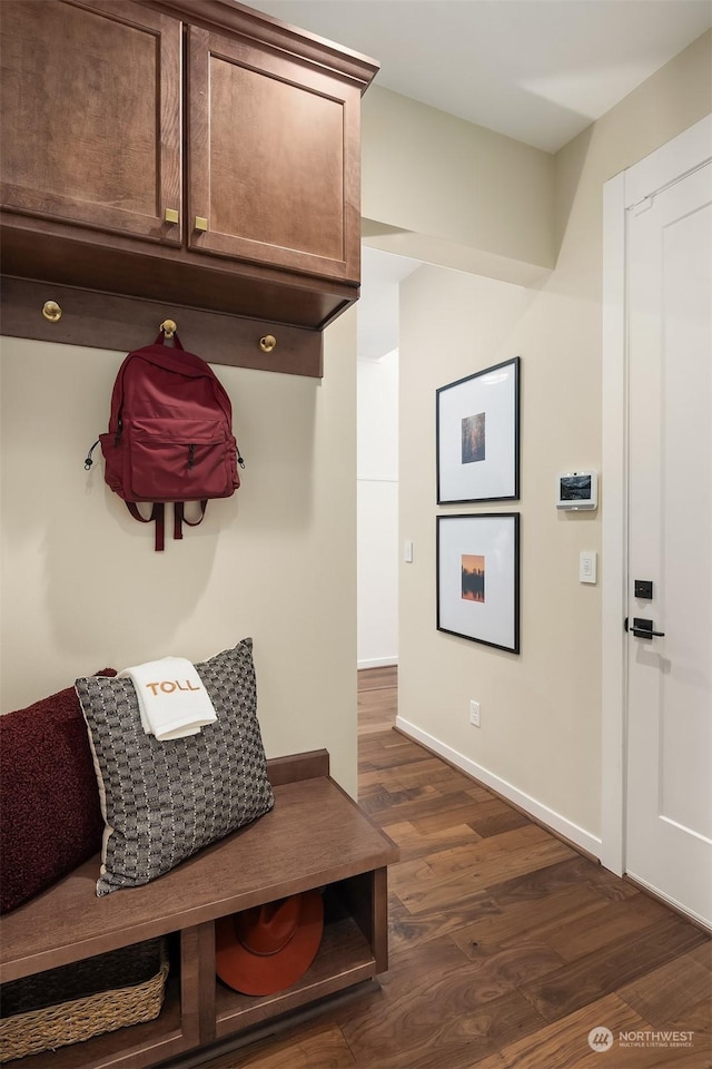 mudroom featuring dark wood finished floors and baseboards