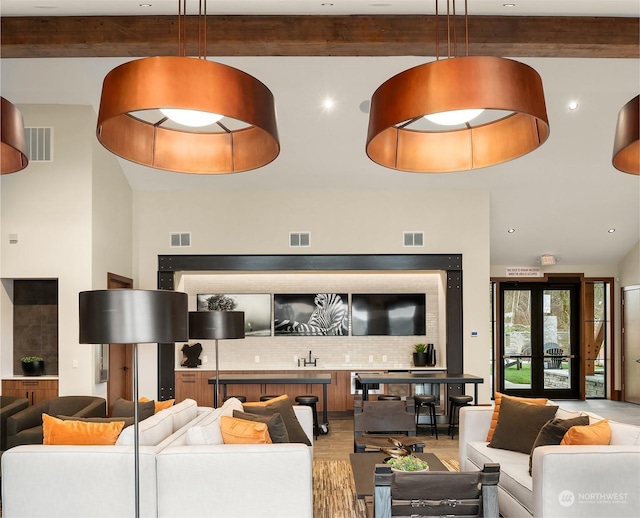 living area featuring light wood-type flooring and visible vents