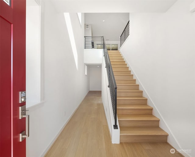 stairs with hardwood / wood-style floors