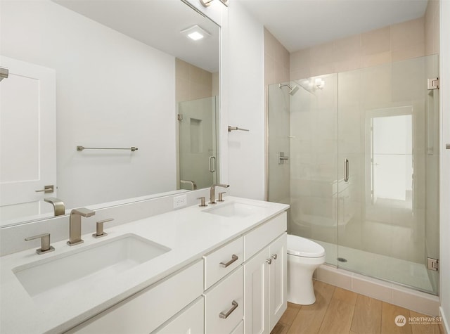 bathroom featuring vanity, toilet, and walk in shower