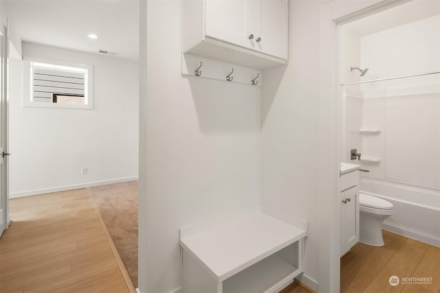 mudroom with light hardwood / wood-style floors