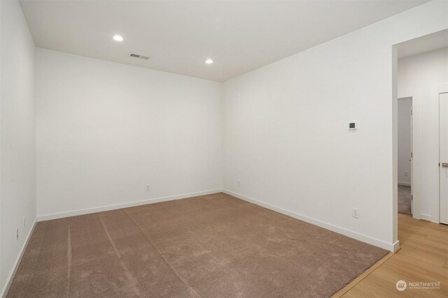 empty room with hardwood / wood-style floors