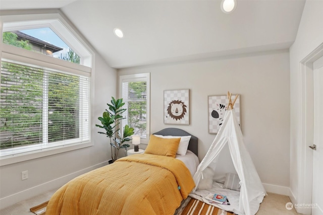 bedroom with carpet flooring and lofted ceiling