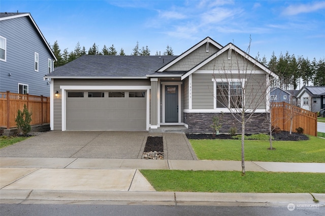 view of front of home featuring a front lawn and a garage