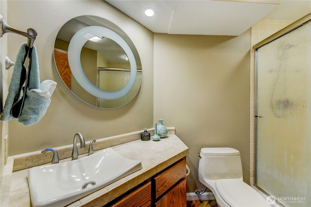 bathroom featuring vanity, toilet, and an enclosed shower