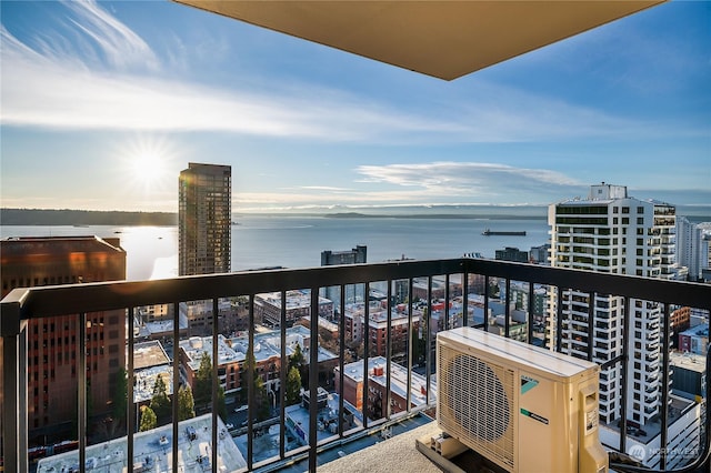 balcony featuring a water view and ac unit