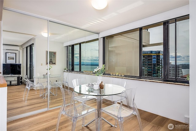 2100 3rd Ave Unit 2503, Seattle, WA 98121 - dining space with wood finished floors and a wall mounted air conditioner