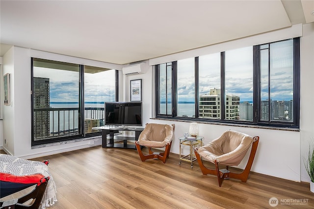 2100 3rd Ave Unit 2503, Seattle, WA 98121 - living area with a wall mounted AC and wood finished floors