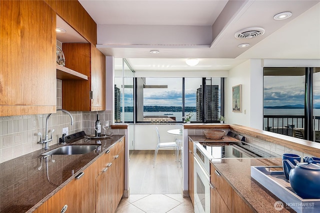 2100 3rd Ave Unit 2503, Seattle, WA 98121 - kitchen with range, open shelves, dark stone countertops, and modern cabinets