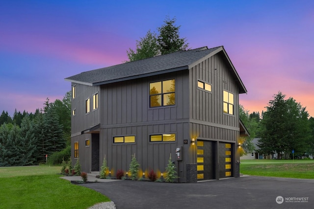 view of front of property with a lawn and a garage