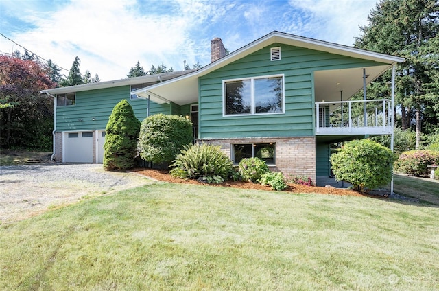 view of front of house featuring a balcony, a front yard, and a garage