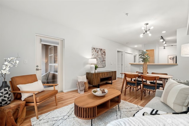 living room with a chandelier and hardwood / wood-style floors