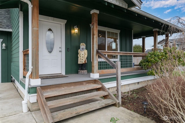 view of exterior entry with a porch