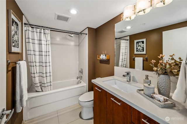 full bathroom with tile patterned floors, vanity, toilet, and shower / bath combo with shower curtain