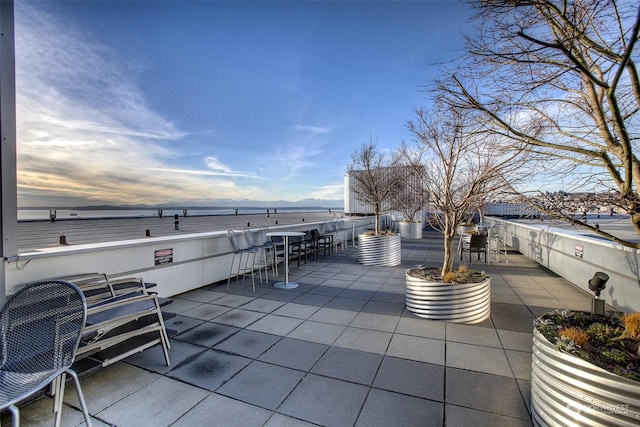 patio terrace at dusk with a water view