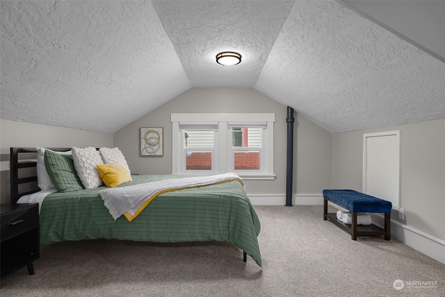 bedroom featuring carpet, lofted ceiling, and a textured ceiling