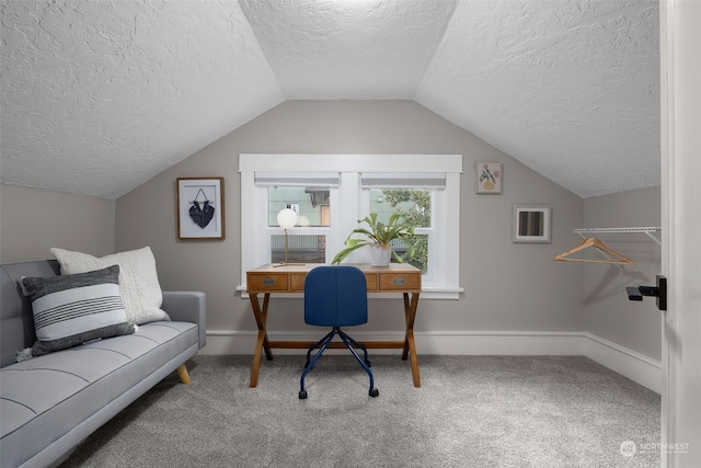 office area with carpet, a textured ceiling, and vaulted ceiling