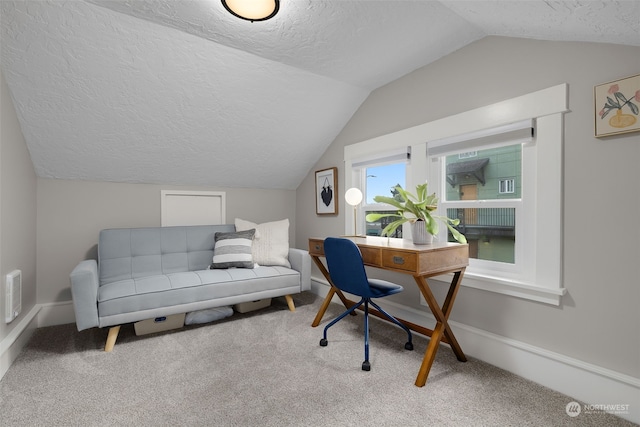 office area featuring a textured ceiling, carpet floors, and lofted ceiling