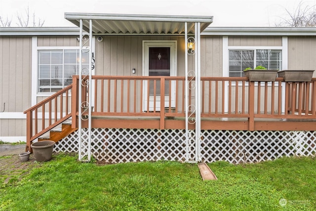 view of exterior entry featuring a yard