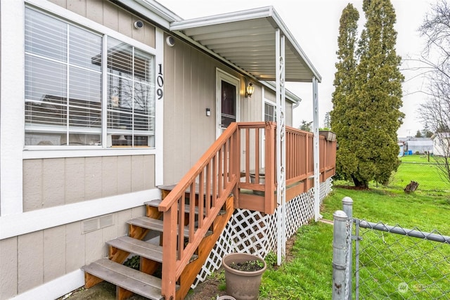 view of exterior entry with a yard