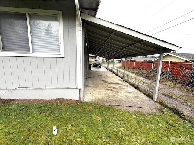 view of side of property featuring a yard and a carport