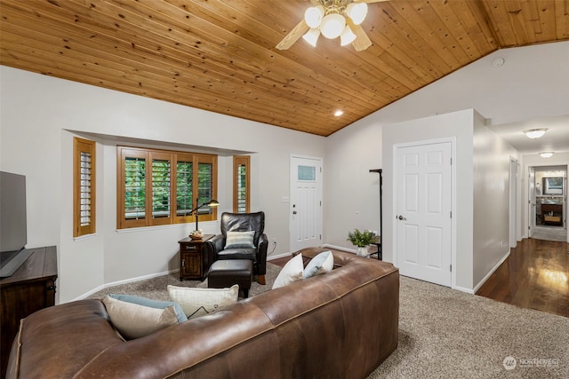 living room featuring lofted ceiling, dark carpet, wooden ceiling, and ceiling fan