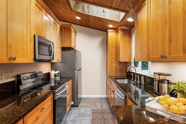 kitchen featuring wooden ceiling, dark stone counters, sink, a skylight, and stainless steel appliances